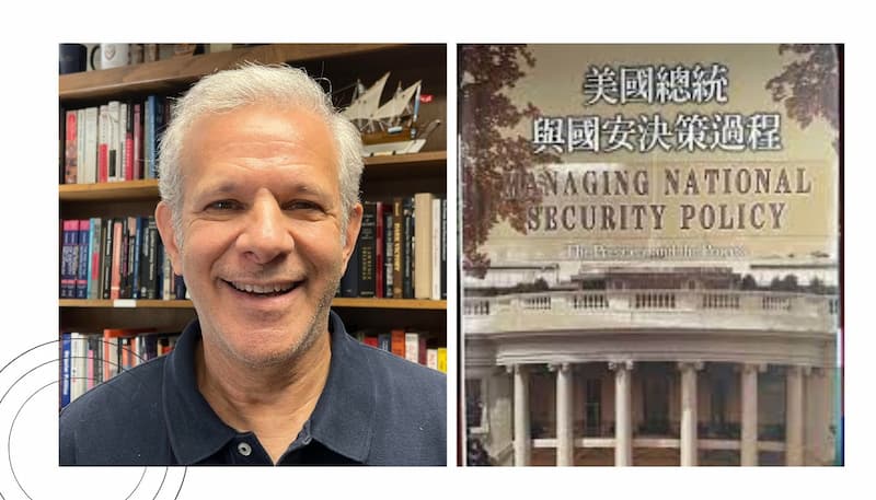 William Newmann alongside his book Managing National Security Policy (Chinese edition)