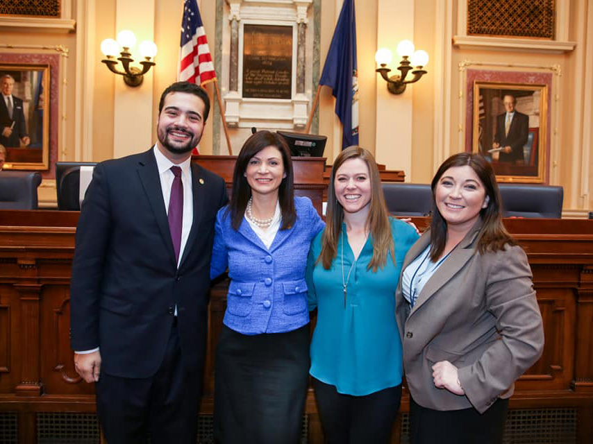 Denver Supinger (far right) stands with three other individuals in the chamber of the Virginia State Capitol